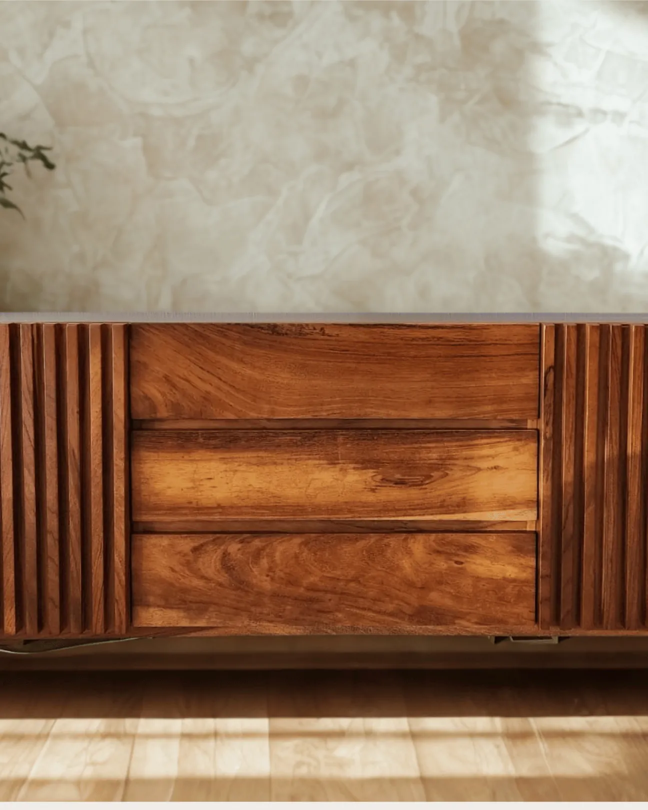 Detail of solid parota wood sideboard with dramatic grain and raking sunlight